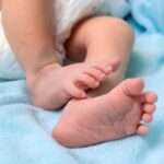 05944020 bigstock new born baby feet on white bl 449030203