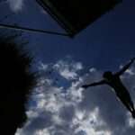 A diver jumps into water during a high diving