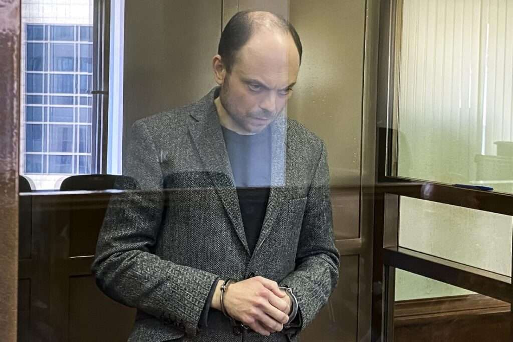 Russian opposition activist Vladimir Kara Murza stands in a class cage in a courtroom at the Moscow