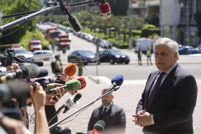 Italian Foreign Affairs Minister Antonio Tajani speaks to reporters