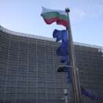 The Bulgarian and European Union flags flap in the wind outside EU