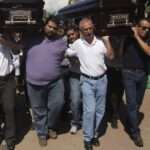 Mexico Men carry the coffins containing the remains of Mexicans