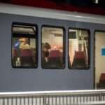 Swiss police officers inspect the inside of a train where passengers travelling from Yverdon to Sainte Croix