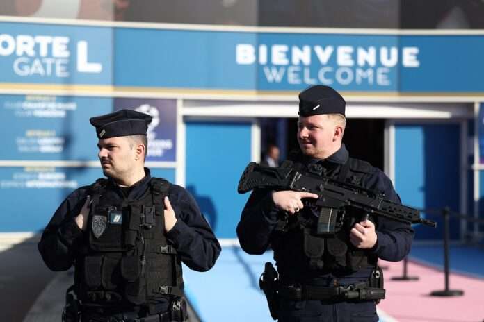 French CRS riot police officers secure the area outside the Parc des Princes stadium
