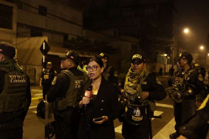 Peru A reporter speaks as police guard outside President Dina Boluartes house during a raid