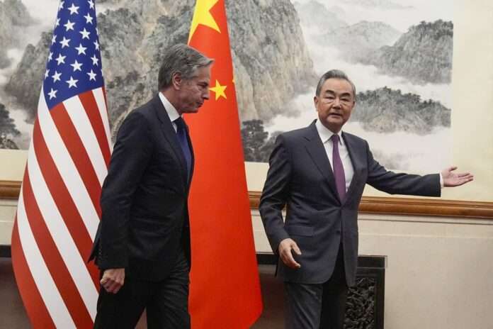 US Secretary of State Antony Blinken L follows Chinas Foreign Minister Wang Yi