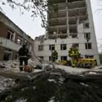 Ukrainian rescuers clear the rubbles of a destroyed building following a missile attack in Chernigiv