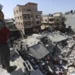 Palestinians look for survivors after an Israeli strike on the Gaza Strip in Rafah