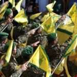 Hezbollah fighters raise their group flags 768x512 1