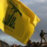 lebanon tense border israeli soldier sets up cameras at their new position in front of a hezbollah flag 768x530 1
